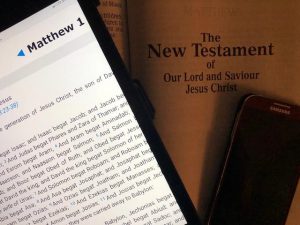 Picture of Tablet, phone and hardcopy of Bible opened to New Testament title page